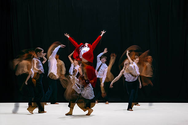 istock Red-jacket leader rising above team in intense motion blur choreography symbolizing conflict and alignment 2260031533