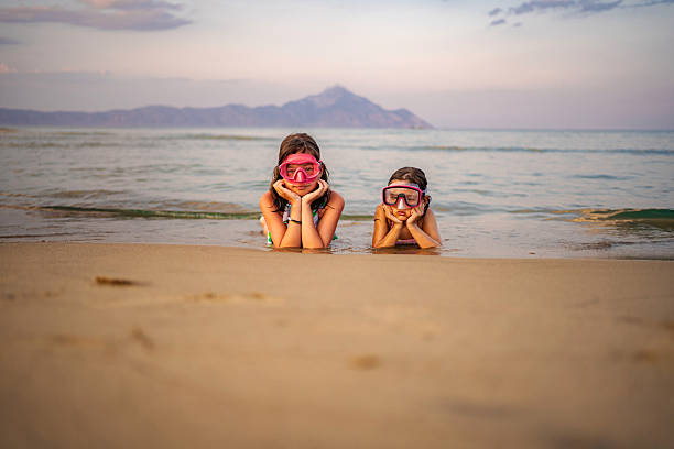 Two Little girls enjoying beach holidays in summer near the sea