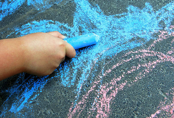 Child plays with colourful chalk