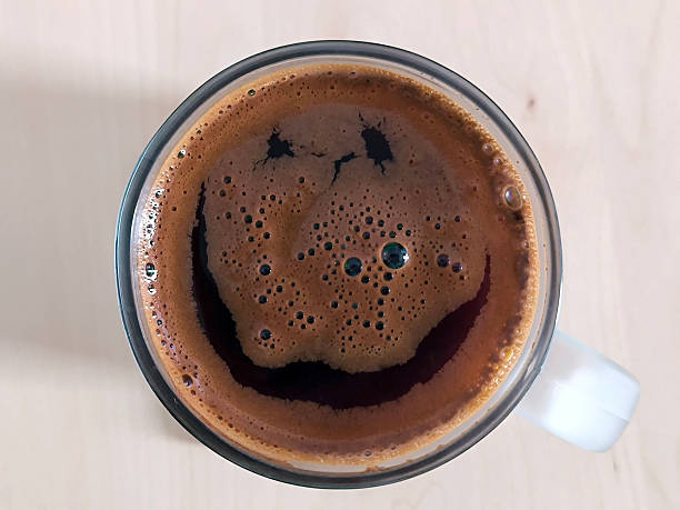 istock black coffee in the mug with smiley face on the surface 2260047211