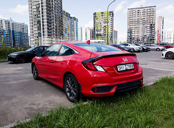 Minsk, Belarus, February 05, 2026 - Rear view of red luxury Honda Civic parked in street