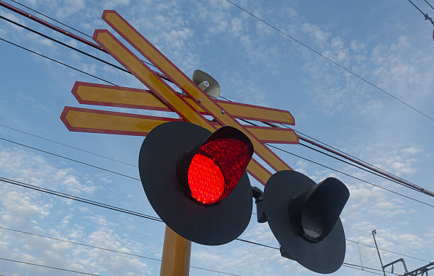 A clear, professional shot of a bright red train signal indicating a mandatory stop. This image represents railway safety, traffic control, and industrial caution. Perfect for transport, logistics, and safety-themed content.