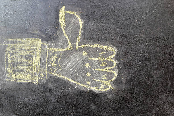 A drawing of a hand with a thumbs up. Chalkboard drawing. A positive like.