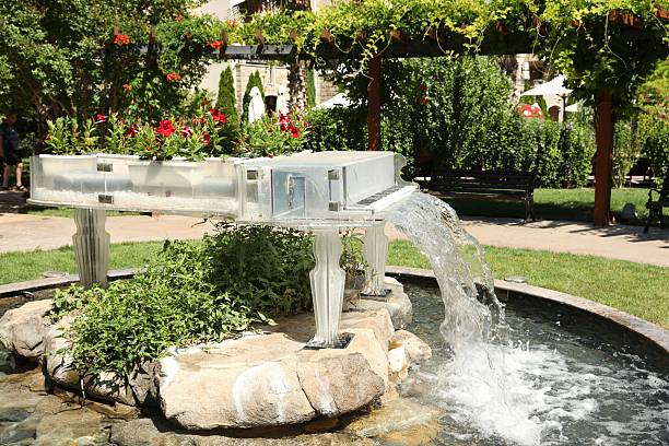 Piano shaped fountain decorated with flowers in park