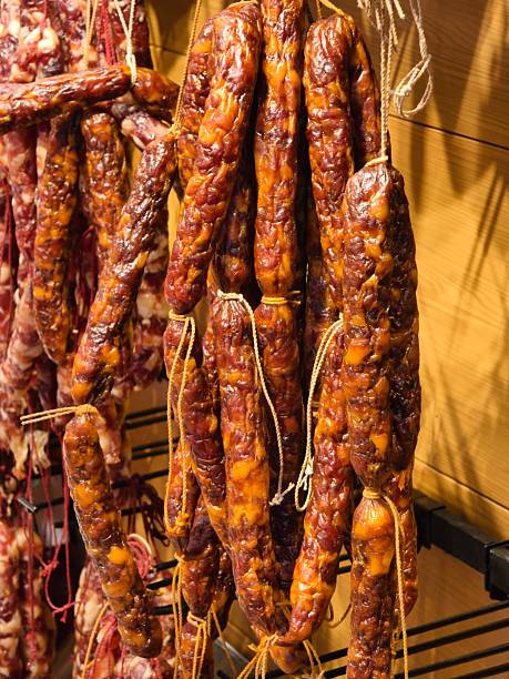 Rows of cured sausages hanging to dry in a traditional curing room