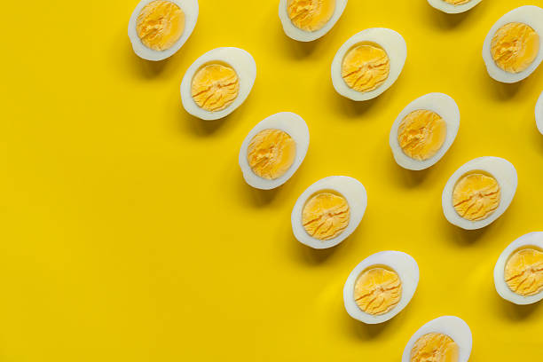 Boiled farm chicken eggs on yellow background