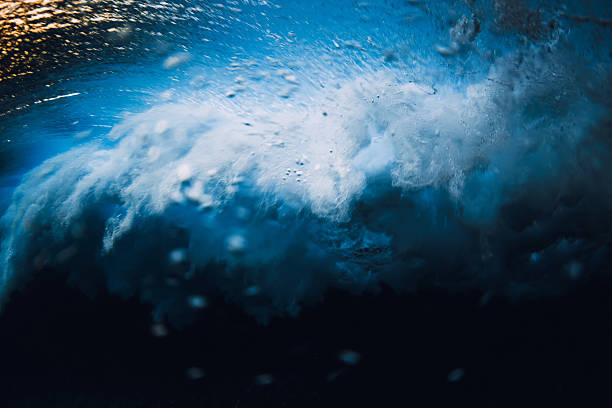 Powerful ocean wave underwater with bubbles and motion, abstract sea energy and natural water texture