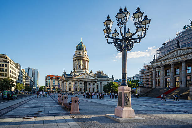 Berlin, Germany, July 24 2009, Gendarmenmarkt square in Berlin features the impressive Konzerthaus and the elegant Französische Dom amidst a dramatic sky.