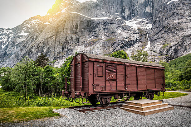Old train car wagon under huge rock mount near Trollveggen. Norway