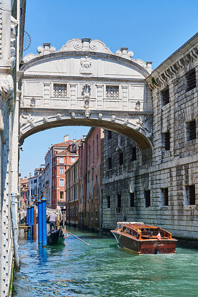 Venice, Italy-April 24, 2024: A gondola passes under the historic Bridge of Sighs in Venice, Italy, showcasing the city's iconic architecture and waterways.