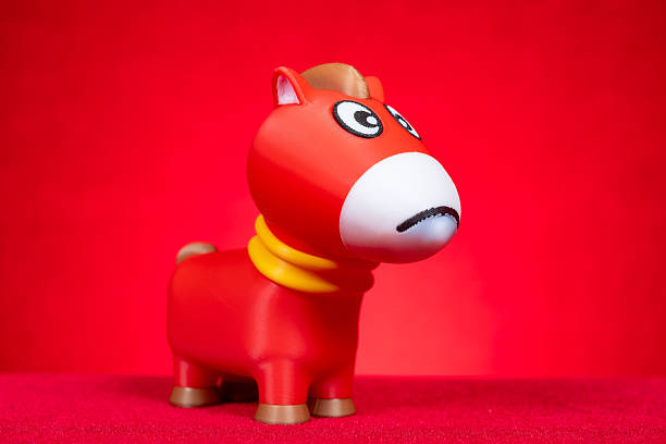 a toy horse with crying face on red
