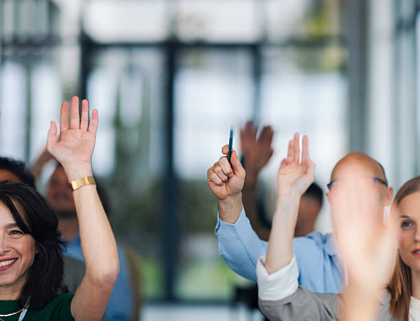 istock Conference Audience Raising Hands At Summit Forum For Education And Business Masterclass Event Session Today 2260129492