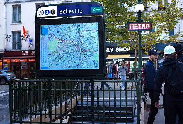 Paris, France - October 27, 2025: Young men chat at the Belleville metro stop in the Belleville district, 20th arrondissement.