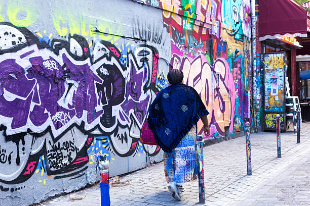 Street artist making a spray graffiti on the wall