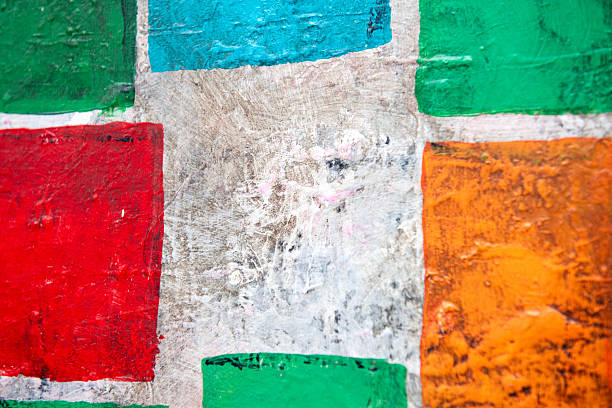 Close-up of abstract painted wall with bold geometric color blocks, contemporary art background with texture.