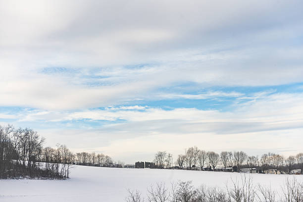 This is a photograph of a snow covered rural landscape in Pennsylvania on a winter day viewed from the highway.