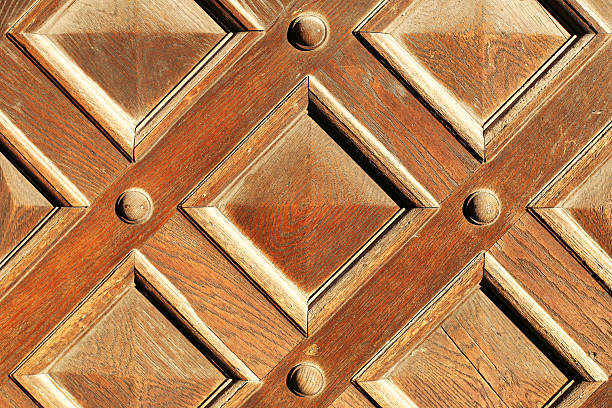 istock Decorative wooden door panel texture. Geometric carved pattern closeup. Natural wood surface background. Traditional craftsmanship detail. 2260144827