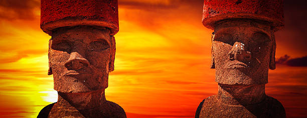 Red sunset over the statues of Easter Island, Chile