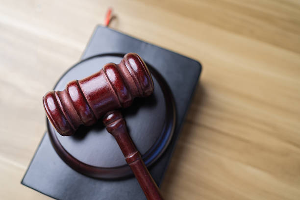 Wooden judge gavel on black legal book. Law justice and courtroom concept