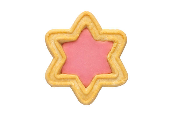 Star-shaped cookies with pink filling on a white background. One cookie isolated close-up