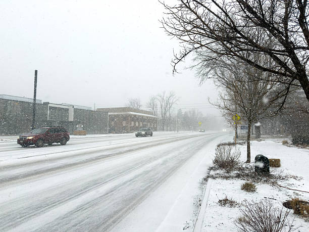 Long Island City, Queens, New York, United States - January 19th 2025:  Parked cars in a small industries area during a nightly snow fall