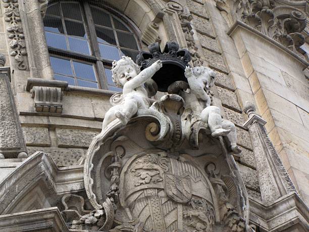 Architectural details of the Justizpalast in Munich, featuring Neo-Baroque ornaments, sculpted faces and figures designed by Friedrich von Thiersch in the late 19th century, DE, 17 Feb. 2011