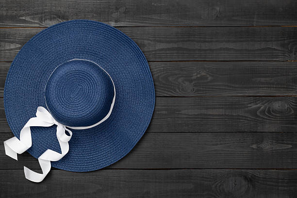Blue beach hat on wooden background,top view
