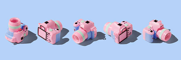 Colorful toy camera on pastel color background, isometric view