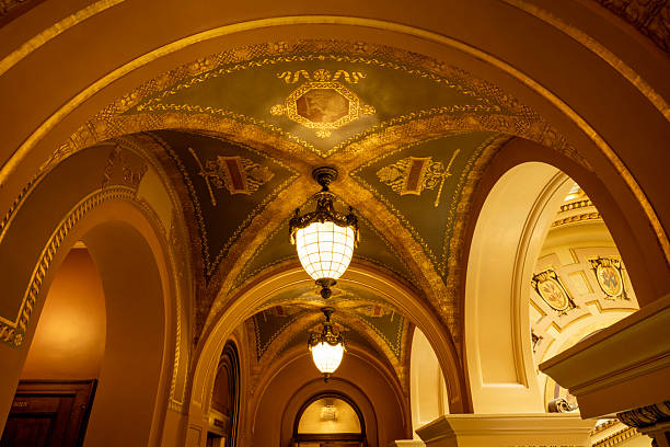 Grand Central station, New York City, USA. The ceiling has gold astrological  or constellation symbols on a green background.