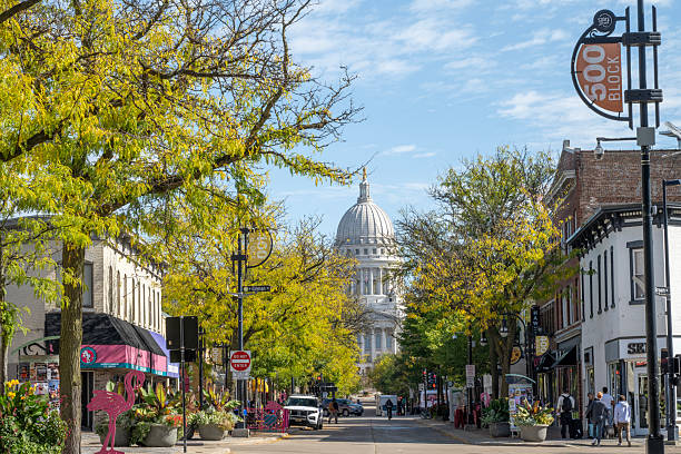 Madison, USA - October 14, 2025. People walking on sidewalk of State Street in downtown Madison, Wisconsin, USA