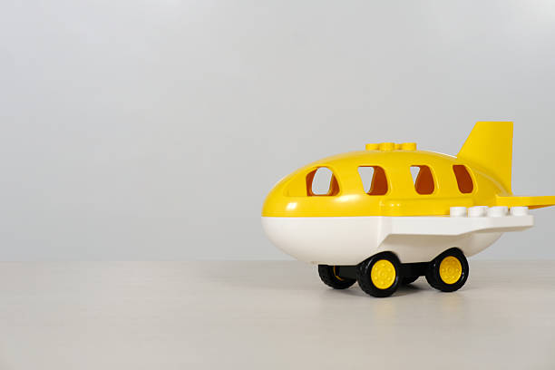 Colorful toy airplane designed for children, positioned on a white surface with plenty of copy space, ideal for playful concepts and creative projects