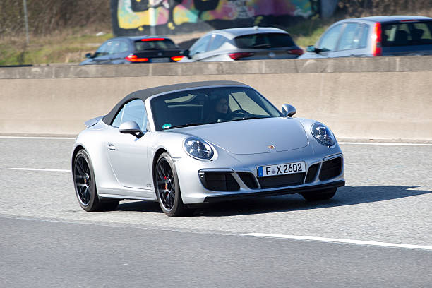 Wallau, Germany - March 20, 2025: A Porsche car on German highway A66 nearby Frankfurt. Porsche is a car manufacturer of luxury high performance cars based in Stuttgart, Germany and founded in 1931.