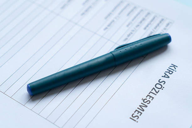 Turkish lease agreement form with pen on it