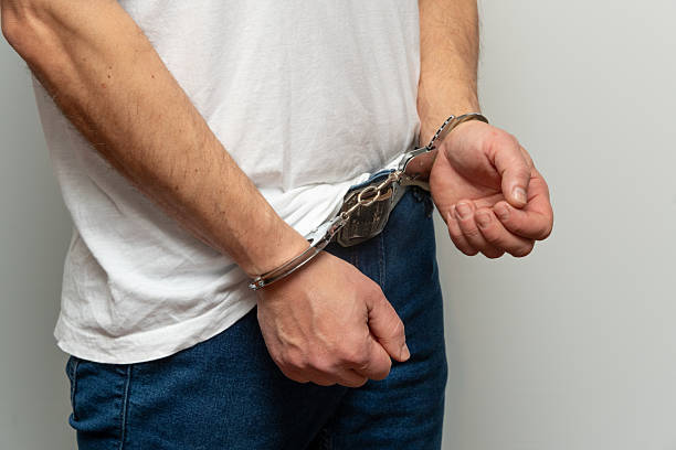 istock Man in handcuffs turned sideways to camera. 2260247773