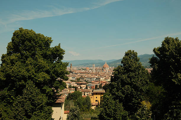Panoramic view of Florence cityscape, including the Cattedrale di Santa Maria del Fiore, from a hillside on a clear day