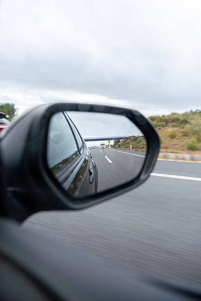 istock A car is driving down a road with a blue sky in the background 2260255379