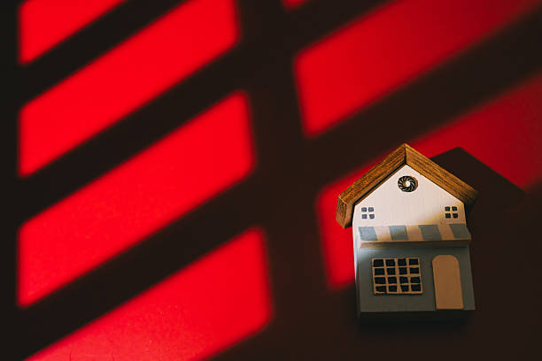 istock Miniature house red background shadow pattern wooden roof small model home concept light and shadow abstract design decorative object cozy feeling 2260261882
