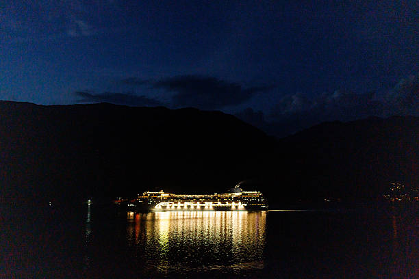 Lit cruiser sails the sea during the night