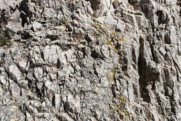 Beautiful side view close up of an abstract natural rock background on a summer sunny day with hard shadows. Conceptual backgrounds and textures.