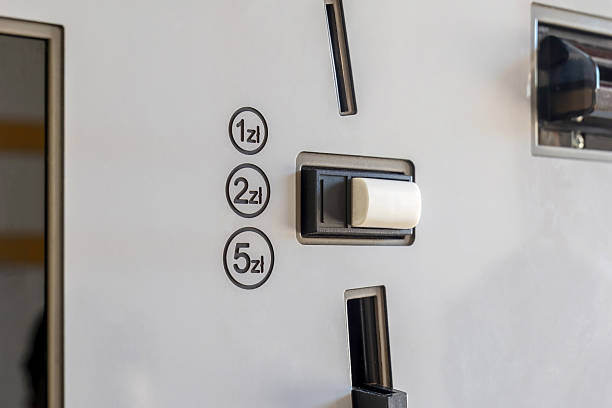 Generic silver ticket or food vending machine coin slot interface accepting Polish zloty coins, payment mechanism closeup. 1, 2, 5 zl currency markings, coin return button, cash transaction, nobody