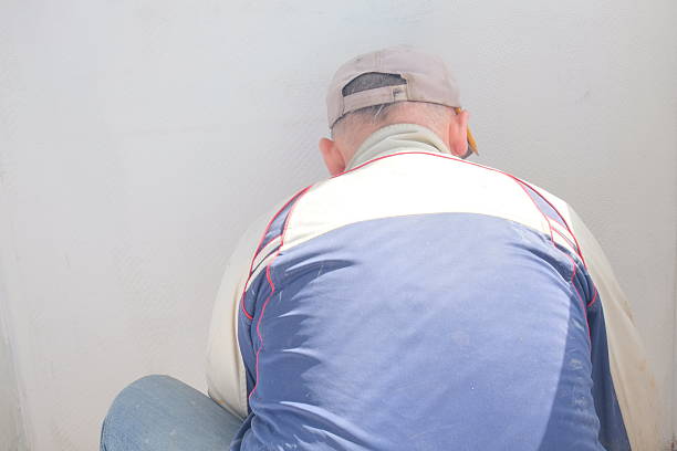 A man is making repairs in the apartment, human hands and objects are visible 1