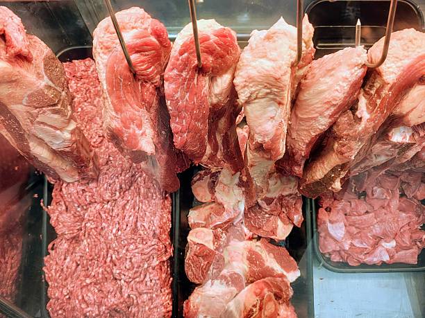 Different cuts of beef in a butcher shop display.