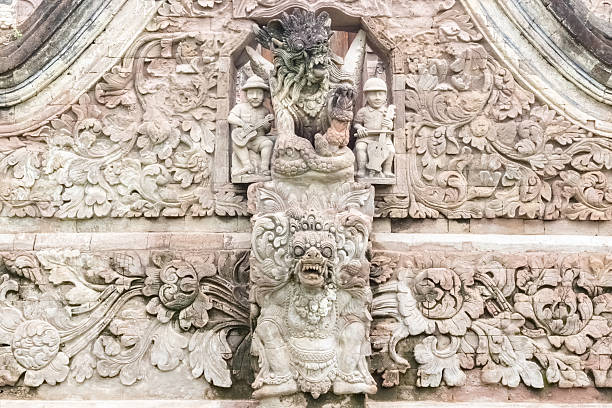 Stone carvings at Pura Beji SangsitTemple in Bali, Indonesia. The European faces depicted note the Dutch influence on the island's history.