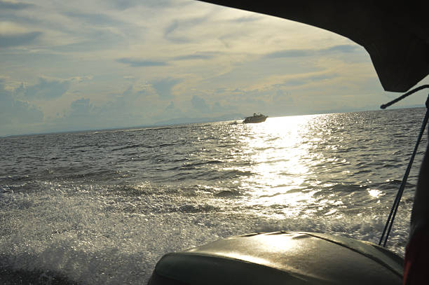 Experience the thrill of a boat ride as sunlight shimmers beautifully on the water. Perfect for travel, adventure and nautical themes.