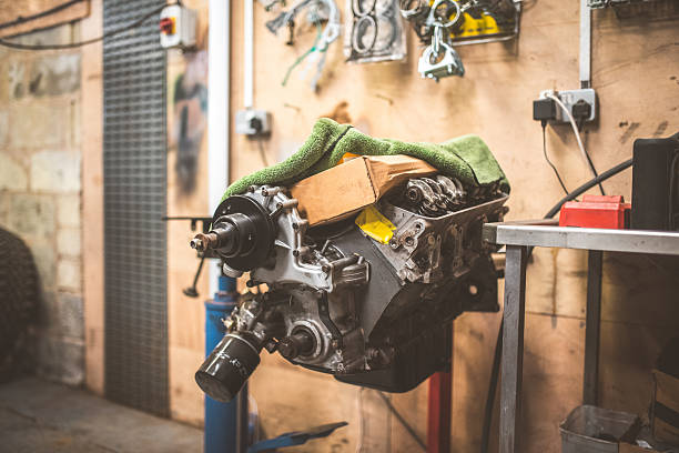 Detailed close-up of car engine components in an automotive workshop, showcasing engineering precision and mechanical elements. Ideal for themes of automotive maintenance and performance.