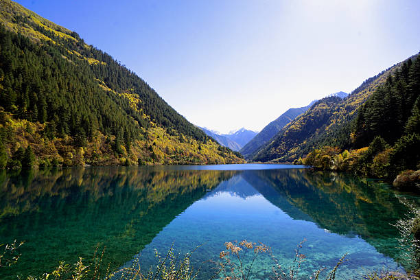 Jiuzhaigou Valley, a UNESCO World Heritage Site in China, is celebrated for its extraordinary natural beauty. The valley features stunning, multi-colored alpine lakes, magnificent multi-level waterfalls, and dense forests, all set against a backdrop of snow-capped peaks. Renowned for its crystal-clear turquoise waters and vibrant seasonal colors, it is a premier destination for experiencing pristine mountain scenery. Autumn is widely considered the best time to visit for the most spectacular views.