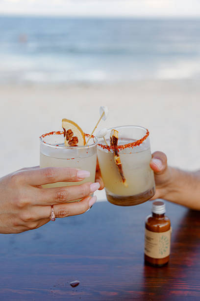 Cheers by the Beautiful Beach Enjoying Refreshing Cocktails While Taking in a Scenic View