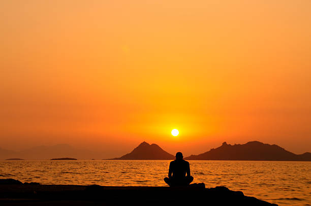 A man prays against the sunset. Unrecognizable Caucasian middle aged male. Side view. Additional themes include help, healing, forgiveness, salvation, humility, courage, conquering adversity, challenge, depression, hurt, anger, seeking, soul, god, godliness, righteousness, discipleship, training, prayer, hope, heaven, and truth. 