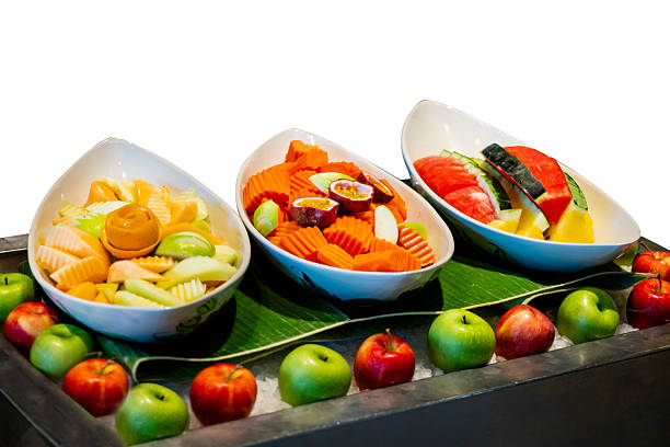 Top view of mixed fruit cut into pieces in the bowl, focus selective