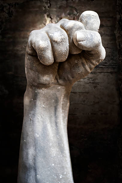 Single fist raised against the sky.